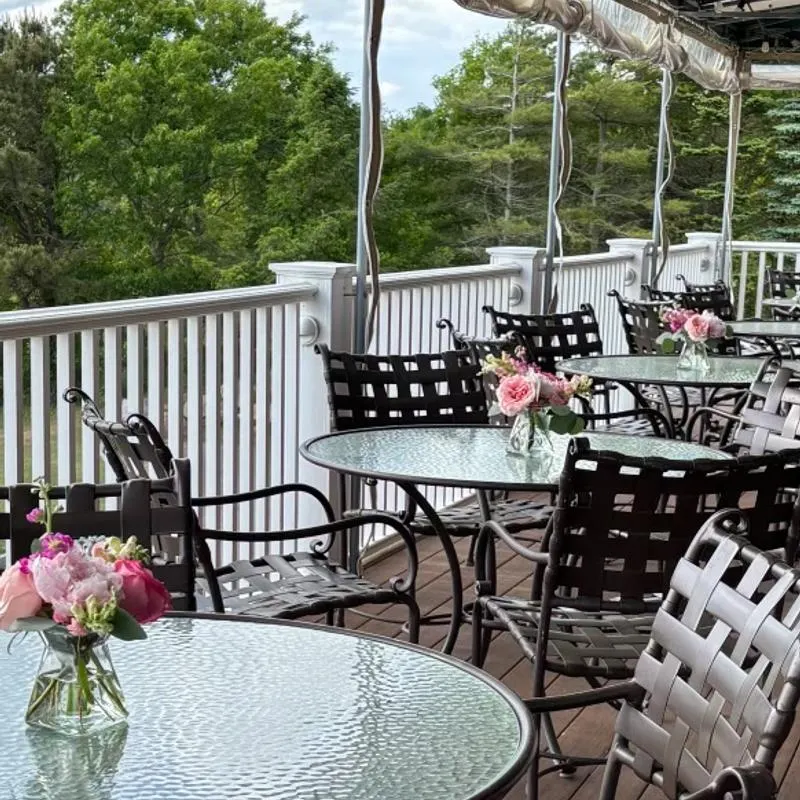Outdoor deck tables overlooking the trees.