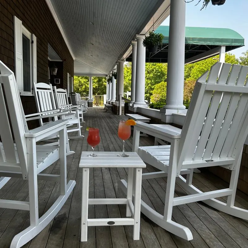 Porch view at the Bog Tavern with white rocking chairs.