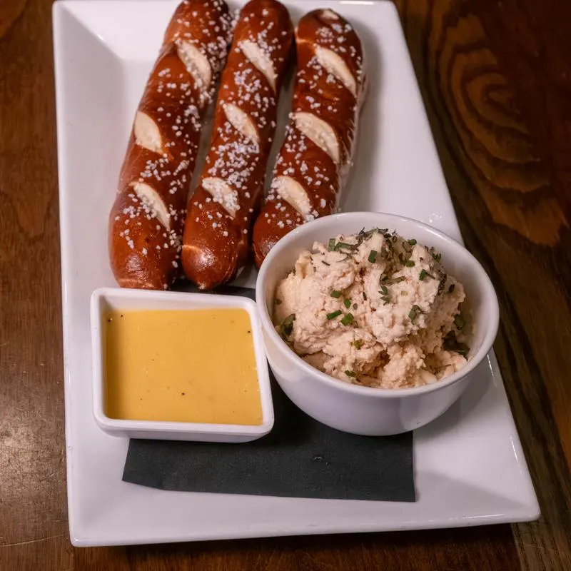 Soft pretzel sticks with mustard and dip.