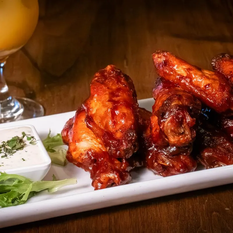 Glazed wings with blue cheese dip.